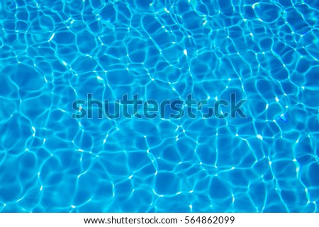water pool  texture background.Blue pool water with sun reflections. Royalty-Free Stock Photo #564862099