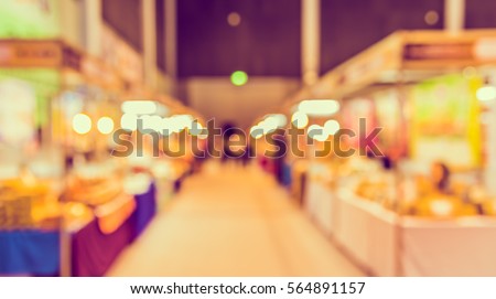 Abstract Blur image of Shopping Mall or  Exhibition Hall and people for background usage . (vintage tone) Royalty-Free Stock Photo #564891157