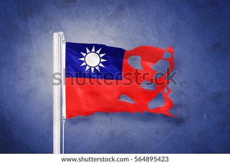 Torn flag of Taiwan flying against grunge background