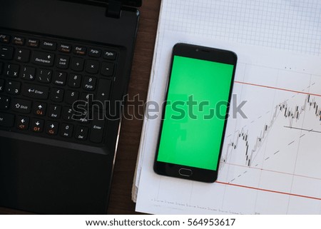 Side view of a man with a marker and stable standing against a concrete wall with graphs drawn on it. Concept of statistics and stocks With the green screen keying for smartphone