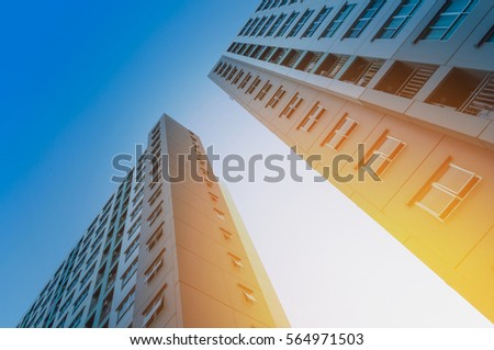 Bottom view of modern skyscrapers in Accommodation at sunset with lens flare filter effect