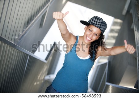 Young happy sportive woman in urban background