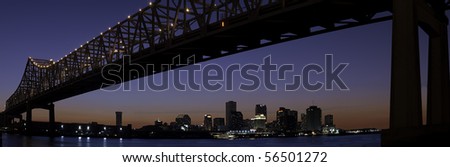 Panorama of downtown New Orleans after sunset with Mississippi River bridge