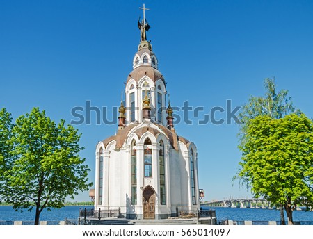 Orthodox temple on the waterfront against the blue sky in the middle spring