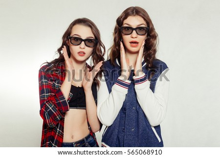 technologies, emotions, lifestyle, people, teens and friendship concept - Two attractive smiling girl in a 3d-glasses slightly tilted to the right. Isolated on white background