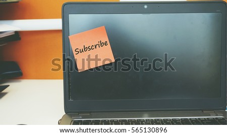 A Technology concept image of a laptop with black screen on an office desk with a red sticky note contain word Saturday