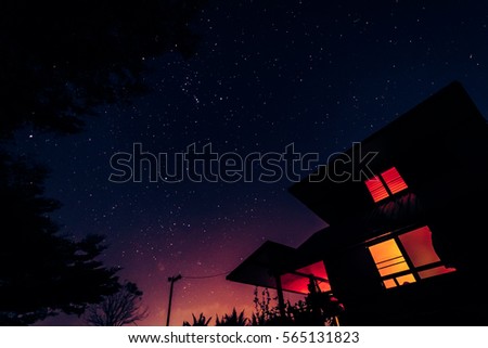 The night with modern house and many stars on sky background