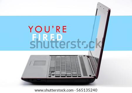a laptop on the table with white background with text YOU'RE FIRED