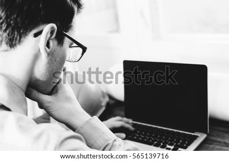 Man engineer working at the laptop on wood table with hardhat. Black and white photo