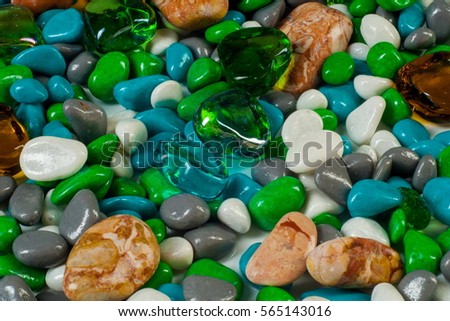 texture, background. Marine pebbles. Background of pebbles, various shells and glass hearts. stones background. 