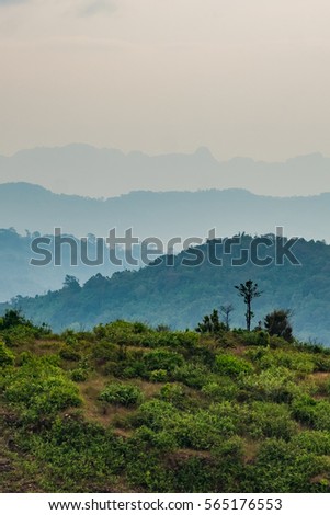 Scenic View Of Mountains Layers Against Mist