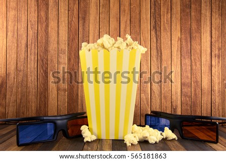 pop corn and 3d glasses on wooden background