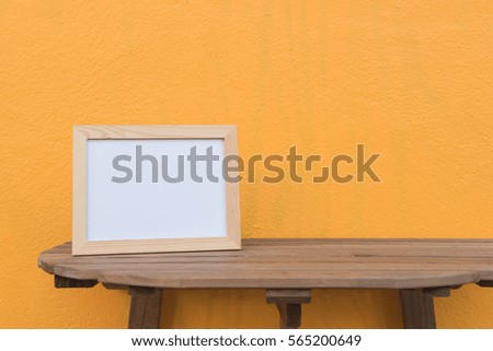 photo Frame on a wooden on Yellow background .