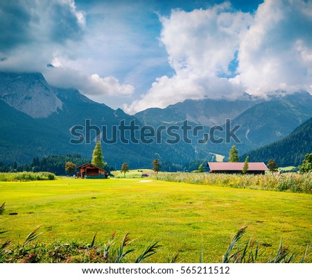 Green meadow on the Golf club Zugspitze, Lermoos village location. Colorful summer morning in  Austrian Alps, Reutte district, state of Tyrol, Austria, Europe. Artistic style post processed photo.
