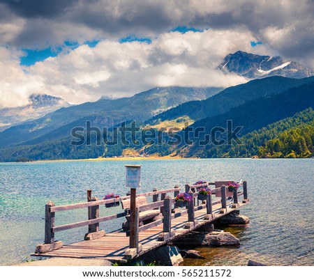 Wooden pier on the Sils lake. Colorful morning view in Swiss Alps, Maloja pass, Upper Engadine in canton of the Grisons, Switzerland, Europe. Artistic style post processed photo.