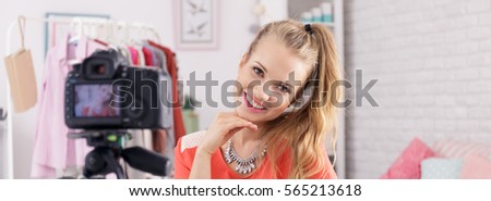 Pretty young woman smiling in front of camera