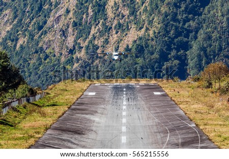 The aircraft is landing on the runway of the Tenzing-Hillary airport Lukla - Nepal, Himalayas 