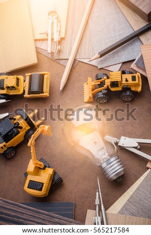 construction and design concept with toy car with wood sample material and drawing tool on leather background