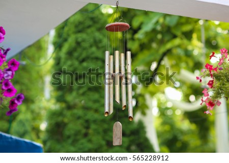 hanging silver wind chimes Royalty-Free Stock Photo #565228912