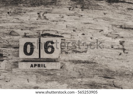 Cube calendar for april on wooden background with copy space