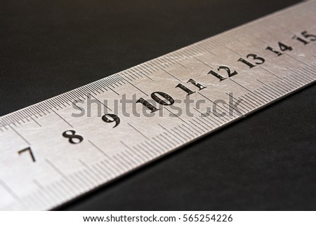 Metal ruler closeup. Measuring tool. Stationery. The number ten in focus. Centimeters. Millimeters. Royalty-Free Stock Photo #565254226