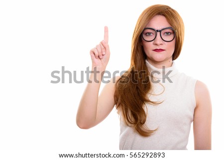 Studio shot of businesswoman pointing up while wearing eyeglasses