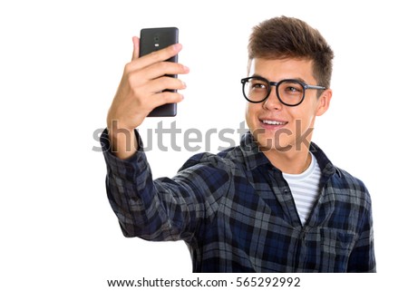 Young happy man smiling while taking selfie picture mobile phone