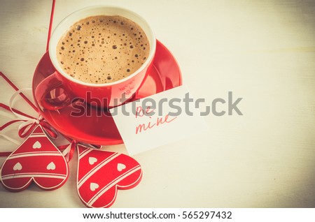 Cappuccino Mug With Wooden Heart and Notes Be Mine on Light Rustic Table From Above. Concept Valentine Day. Toned Image. Selective Focus.