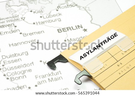 German map and a hang folder with the German word for asylum application