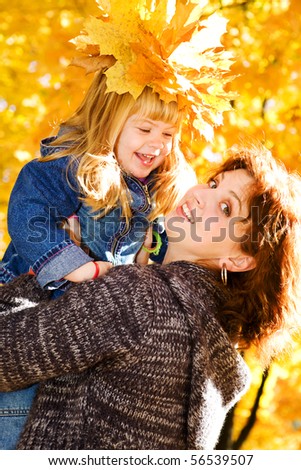 Happy mother and daughter in the autumn park