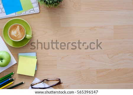 Office desktop with office accessories, Desktop with business objects and snack foods.Hero header Concept. Royalty-Free Stock Photo #565396147