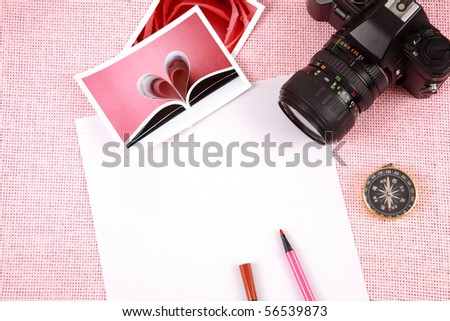 Clutter of objects stacked on pink background