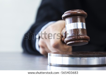 Judge with gavel on table Royalty-Free Stock Photo #565403683