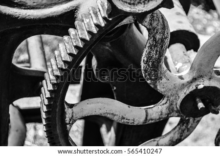 vintage industrial black and white image of cogs and wheels from machinery
