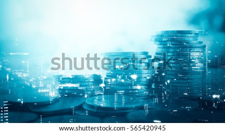 Double exposure of city and stack of coins for finance and banking concept