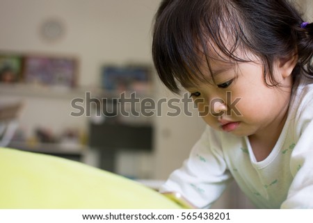 Little girl watching cartoon on mobile device.