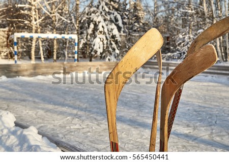 Hockey-sticks on ice rink                               
