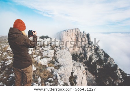Woman photographer taking photo of mountains landscape on background Travel Lifestyle concept adventure vacations outdoor