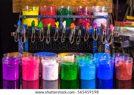 ink on rubber handle hang on place above plastisol ink in cans ready for print tee shirt
