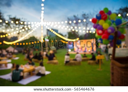 Abstract blur people in night festival city park bokeh background Royalty-Free Stock Photo #565464676