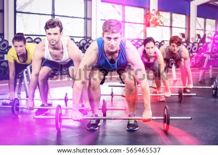 Portrait of athletic men and women working out at crossfit gym