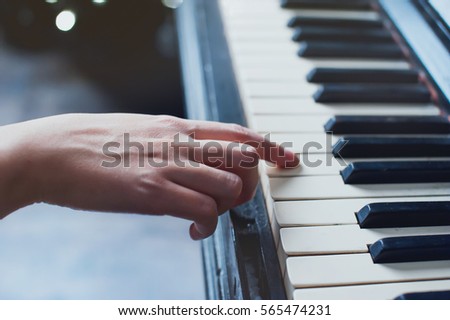 girl playing on an old piano vintage