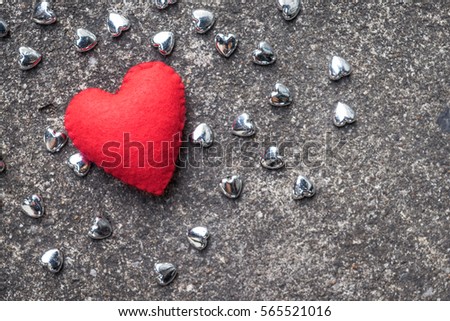 red heart with small siver heart on cement floor,  valentine and love concept