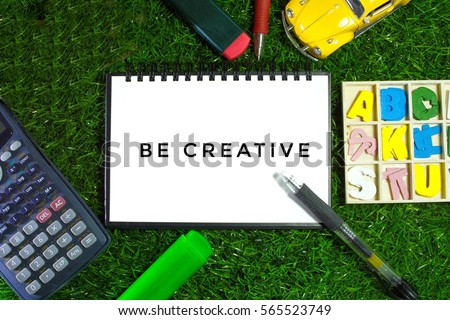 be creative words with stationaries and grass background