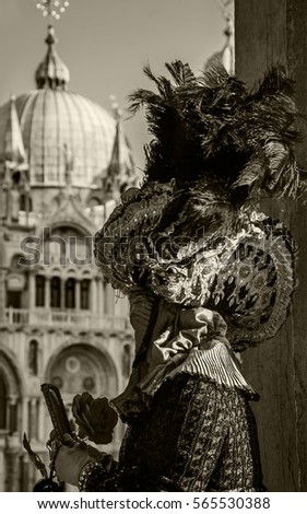 Romantic mask with rose flower and mirror looking at Basilica San Marco. Infidelity sin concept. Sepia.