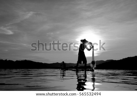 People fishing in river in Thailand. Black and white picture and silhouette.