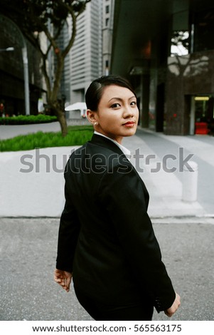 Business women walking, turning to looking at camera