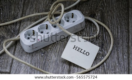 socket on the floor on wooden floor, words on a paper sticker