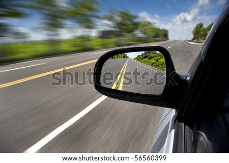 car driving through the empty road and focus on mirror Royalty-Free Stock Photo #56560399