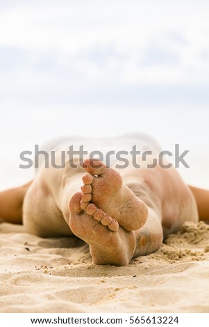 young woman lying on the beach in the sand